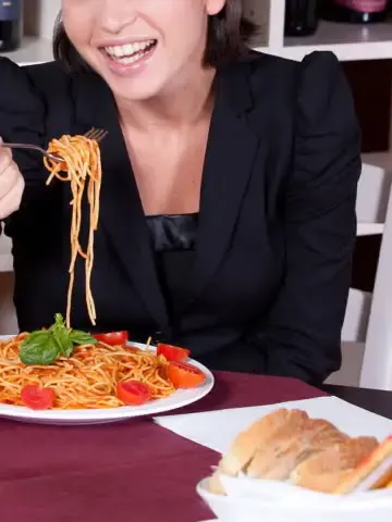 woman eating pasta in a restaurant