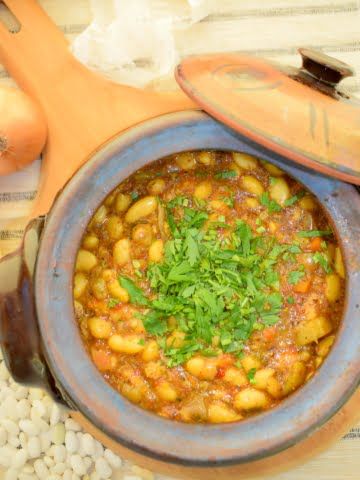overhead view of baked beans in clay pot