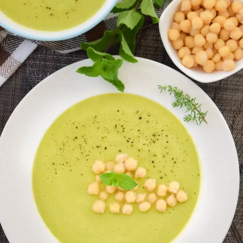 overhead shot of a plate full of vegan green peas cream soup