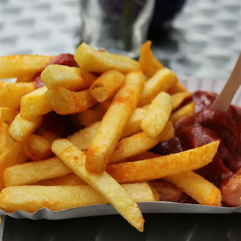 a plate with potato fries with ketchup