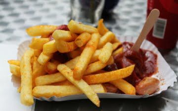 a plate with potato fries with ketchup