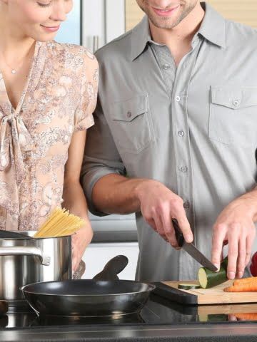 a young couple cooking in the kitchen