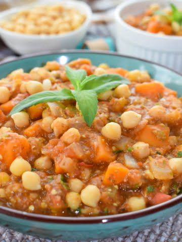 A plate full of vegan chickpea stew with eggplant and sweet potato ¾ shot
