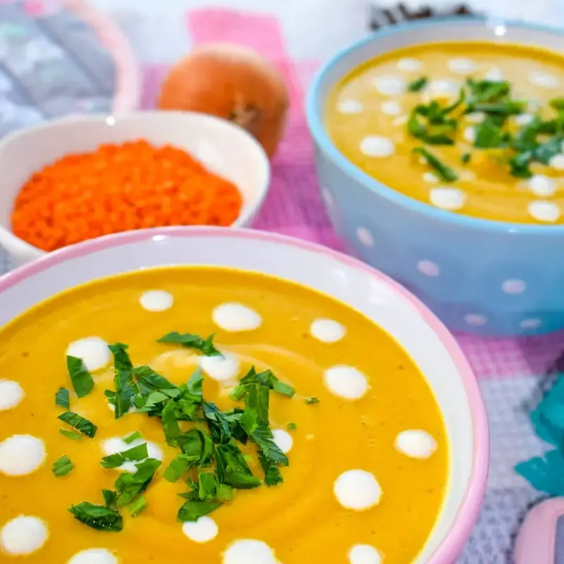 a bowl full of vegan red lentils cream soup ¾ shot