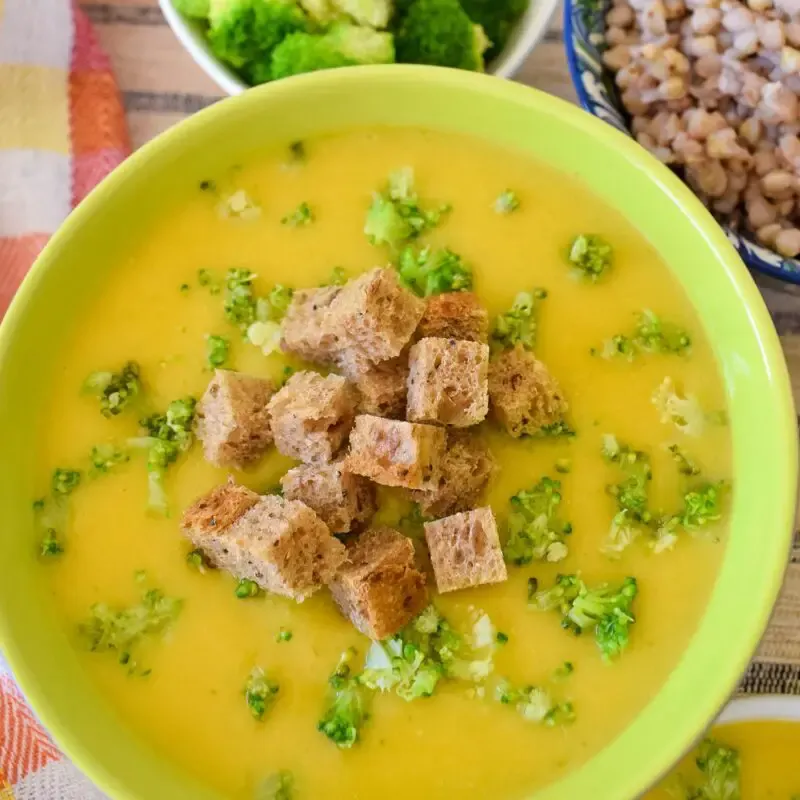 A bowl of vegan broccoli cream soup overhead view