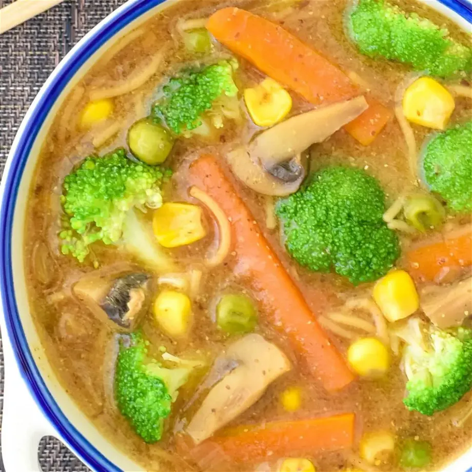 A bowl of vegan miso broccoli soup overhead shot