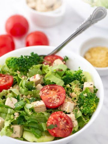 A super fresh and colorful salad made with only plant-based ingredients. Absolutely oil-free! Green salad, cucumber, cherry tomatoes, green onions all mixed together with super nutritious broccoli and delicious tofu cubes!
