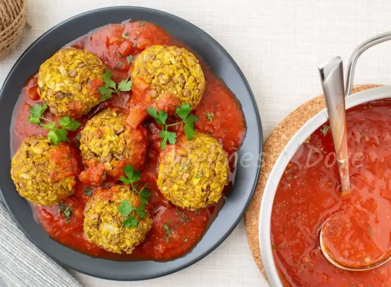 the vegan meatballs in a plate and a pot of tomato sauce
