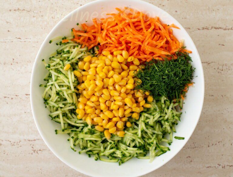 a large bowl with the ingredients of the vegan salad, unmixed