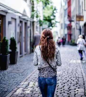 Woman walking down a small town street