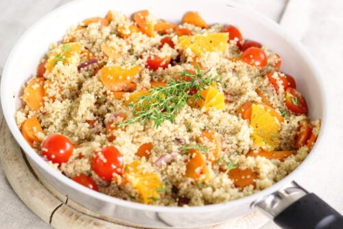 cooked quinoa with veggies in a pan
