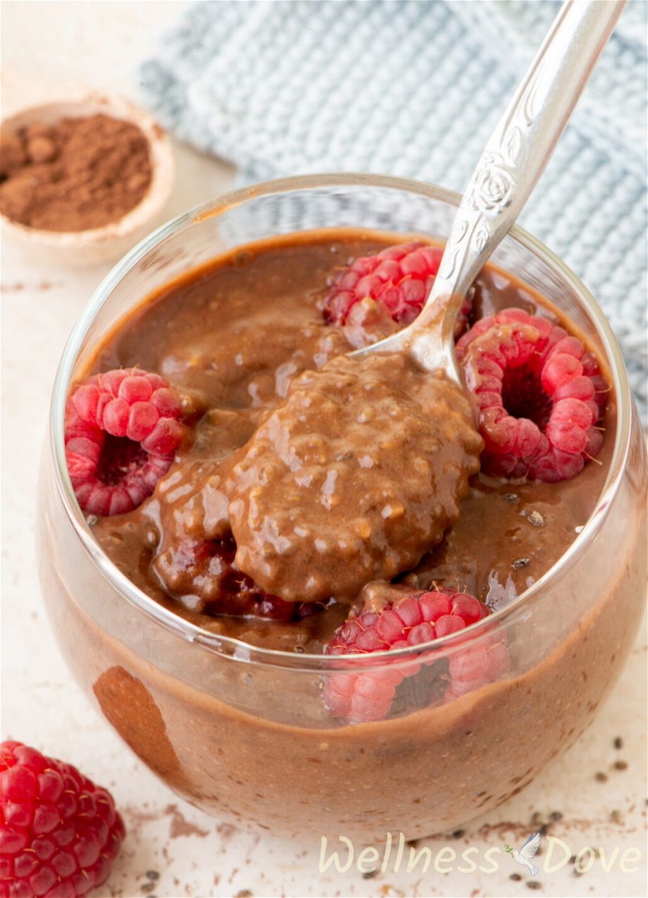 3/4 close up shot of the easy vegan chocolate chia seeds pudding, with a spoon inside