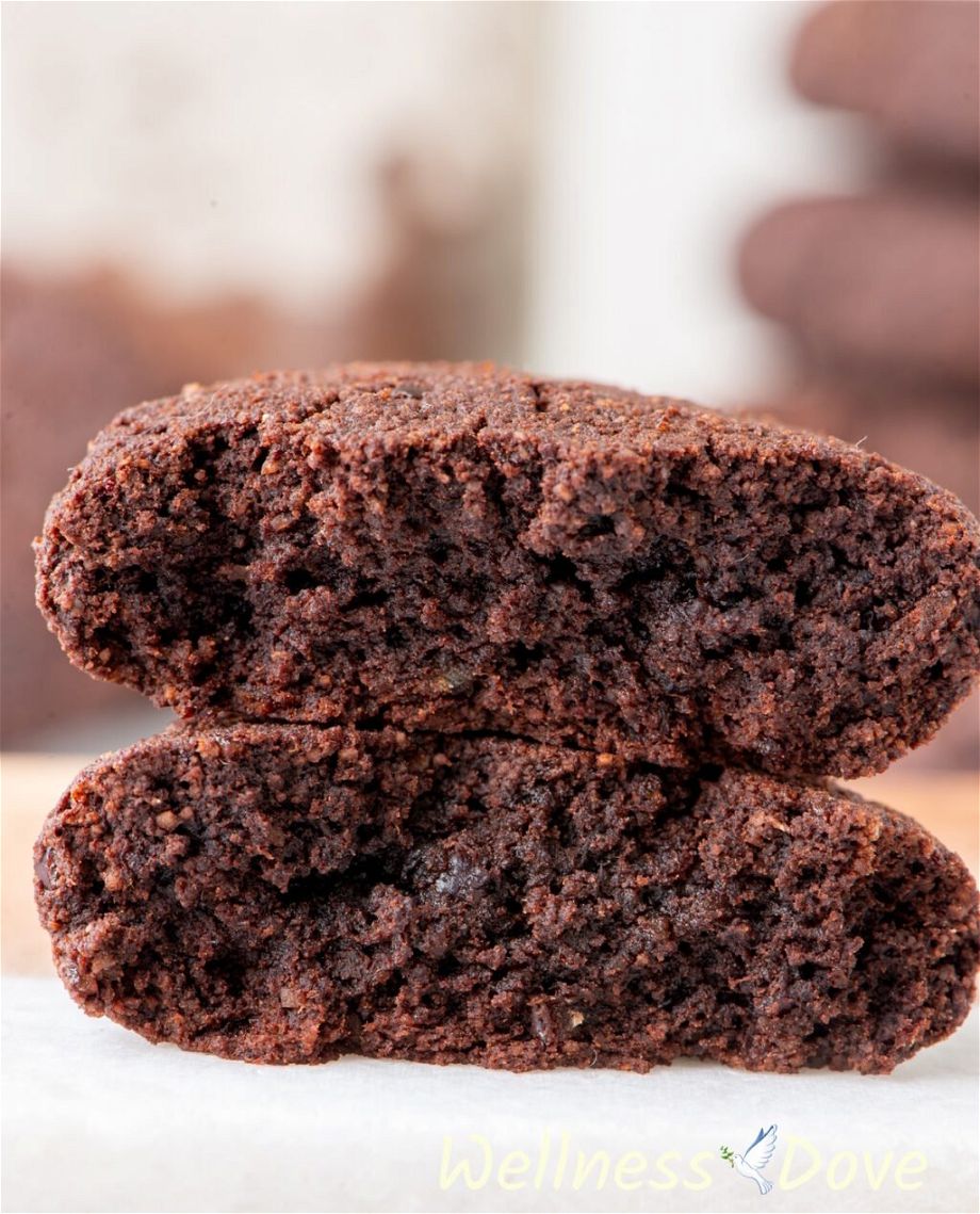 a close up view of a Easy Chocolate Almond Vegan Cookie that is split in half and the two halves are on top of each other
