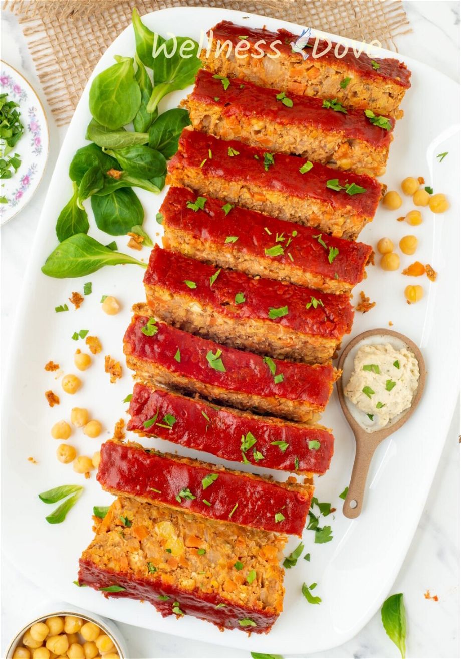 the vegan chickpea meatloaf is cut into pieces and shot from above