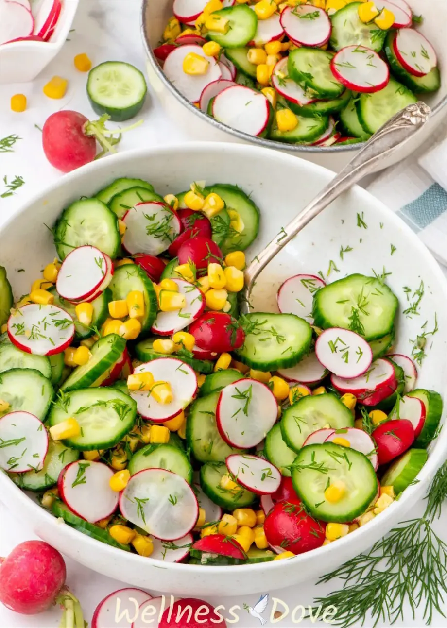 the Fresh Cucumber Summer Vegan Salad in a bowl, half of the salad is missing, probably eaten