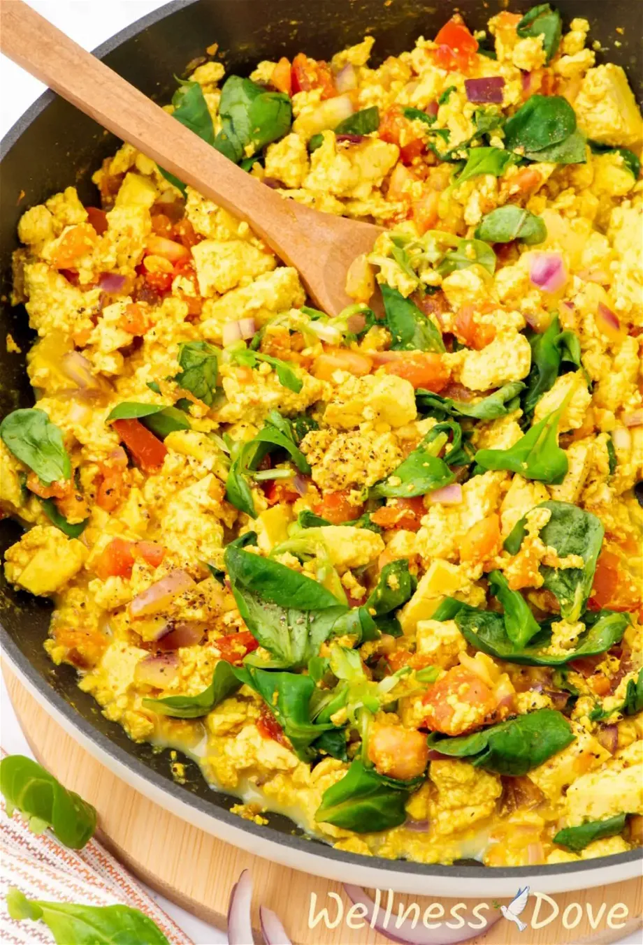 a close up 3/4 photo of the quick curried tofu vegan egg scramble in a pan