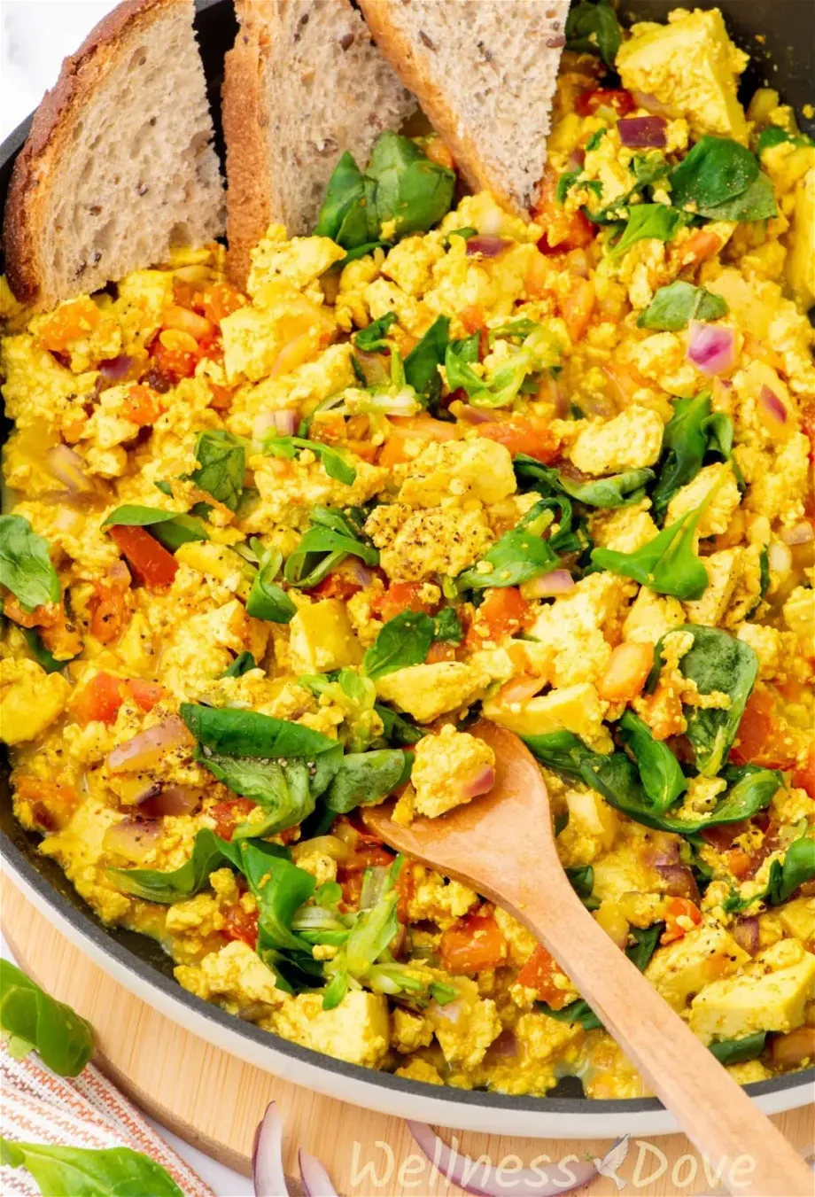 a close up photo of the quick curried tofu vegan egg scramble in a pan