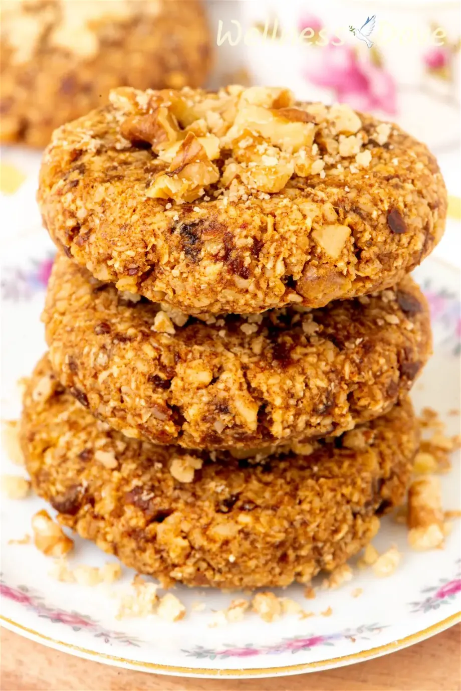 a macro photo of the Easy Oatmeal Walnut Vegan Cookies, 3 of them stack on top of each other