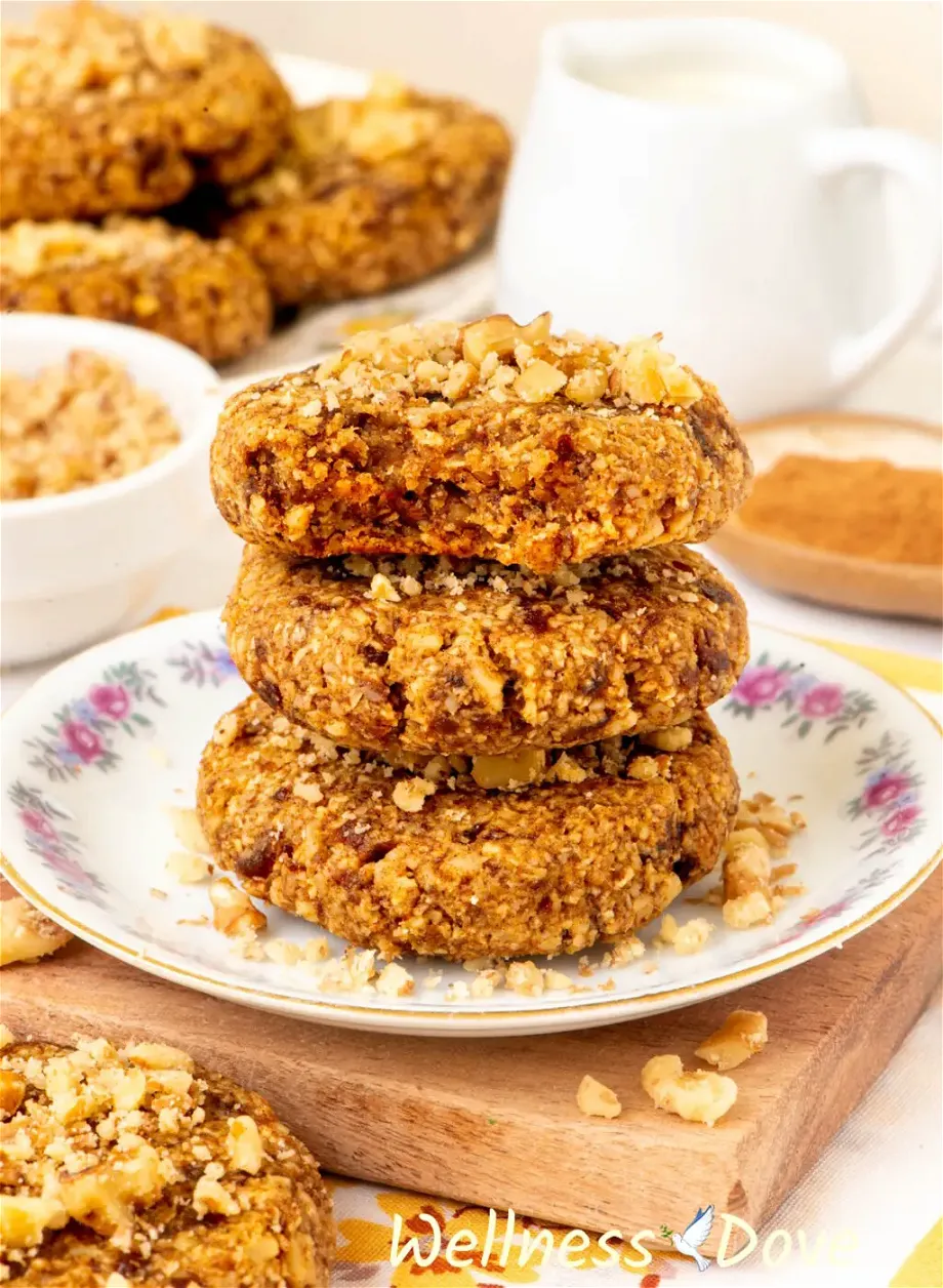 three of the Easy Oatmeal Walnut Vegan Cookies stacked on top of each other in a small plate