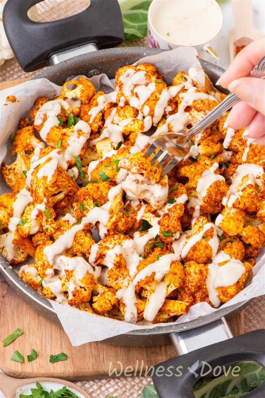 the Oil-free Oven Roasted Cauliflower in a pan with cashew sauce poured over them