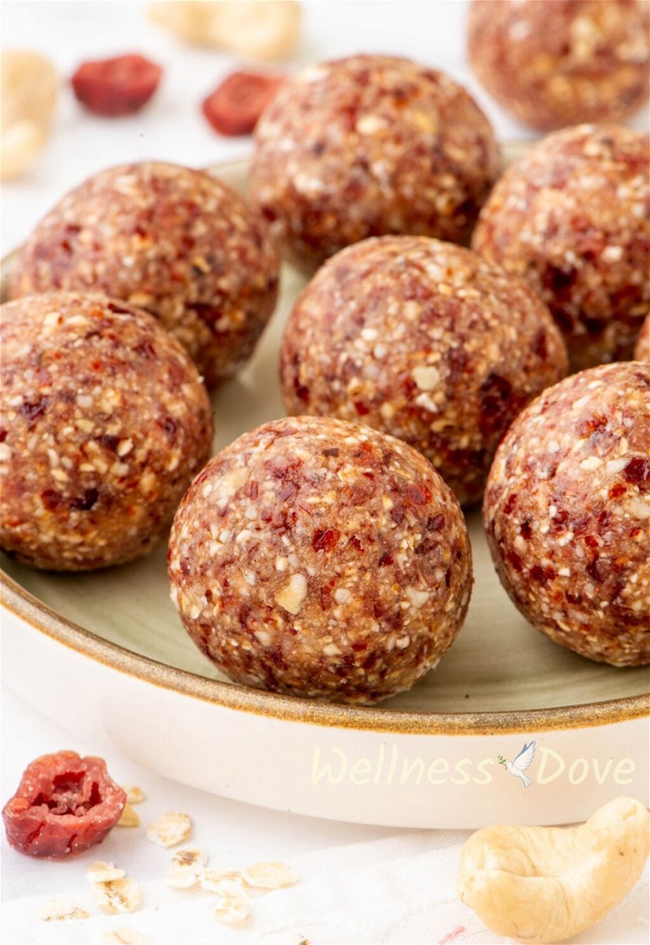 a 3/4 angled photo of the The Cranberry Oatmeal Vegan Energy Bites in a small green plate