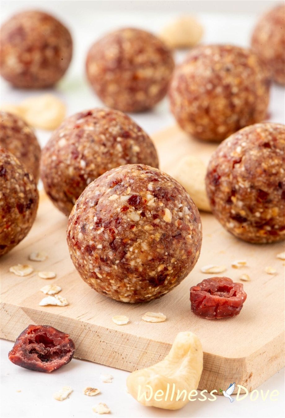 the The Cranberry Oatmeal Vegan Energy Bites on top of a small chopping board