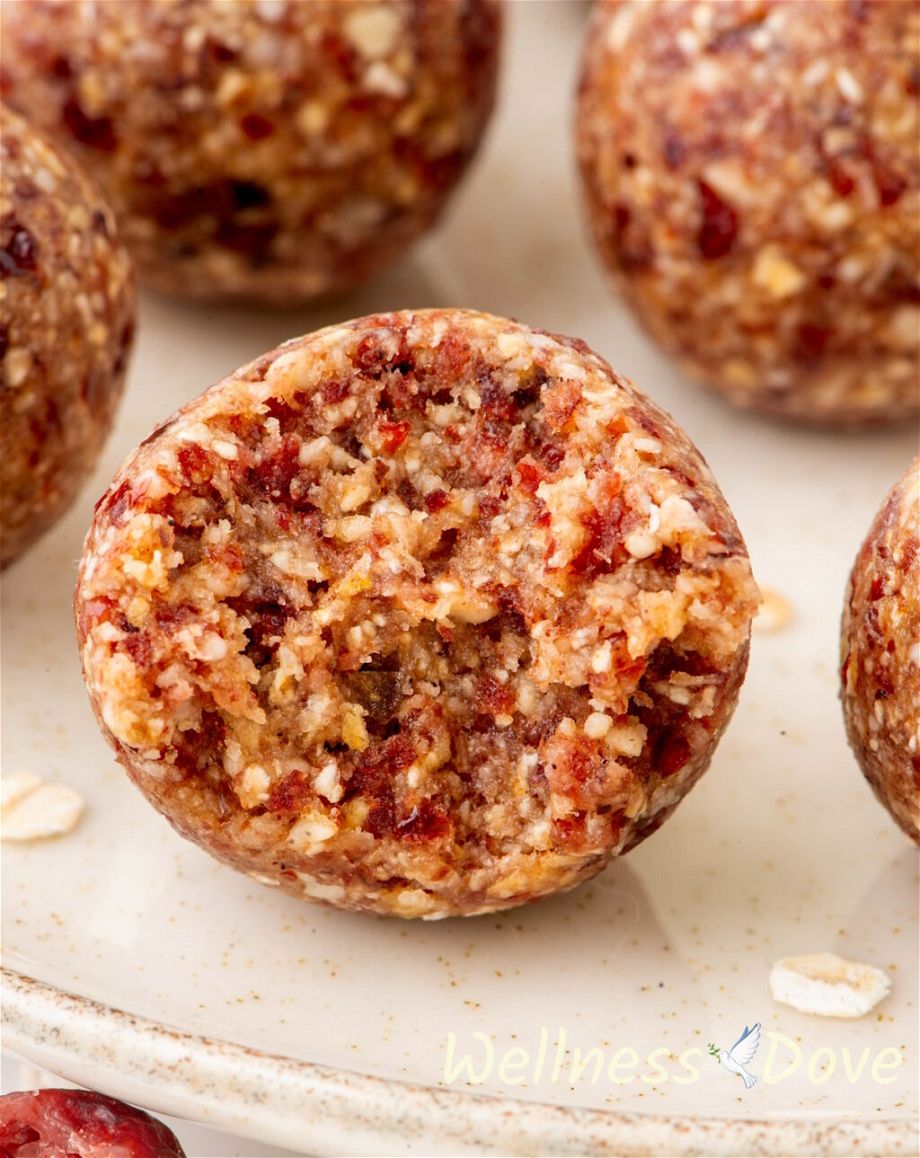 A close up photo of one of the Cranberry Oatmeal Vegan Energy Bites 