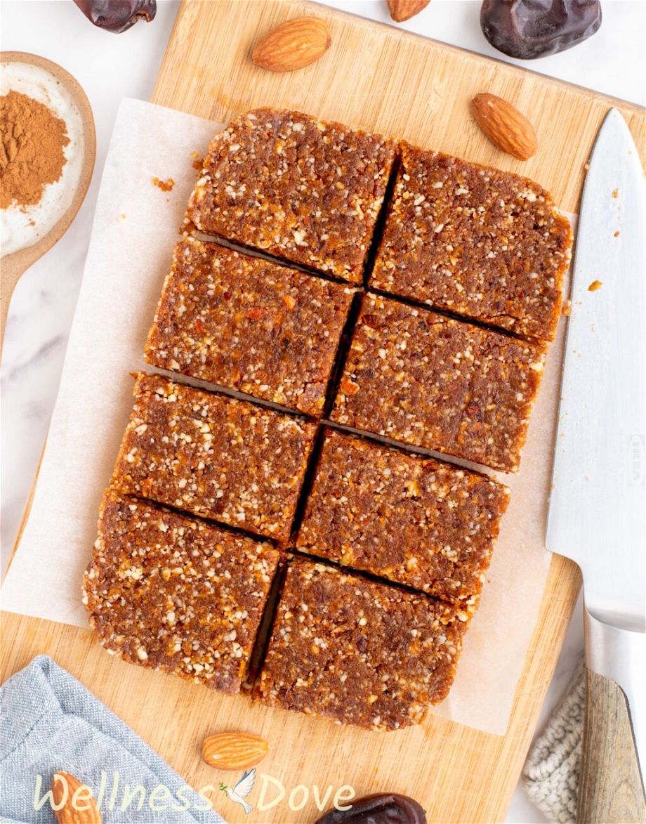 the Almond Peanut Butter Bars, on top of a chopping board and cut into pieces