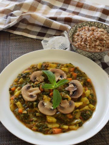 ¾view of a plate full of ginger turmeric nettle stew