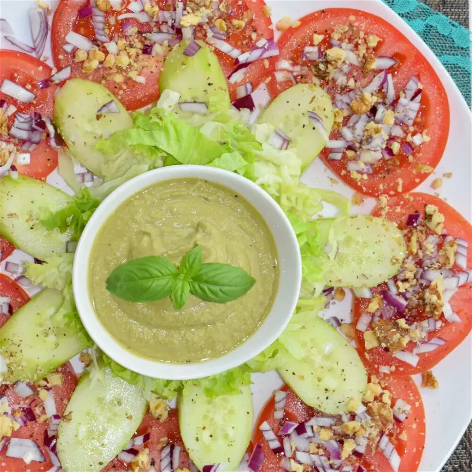 overhead view of tomato salad with basil pesto