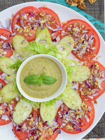 overhead view of tomato salad with basil pesto