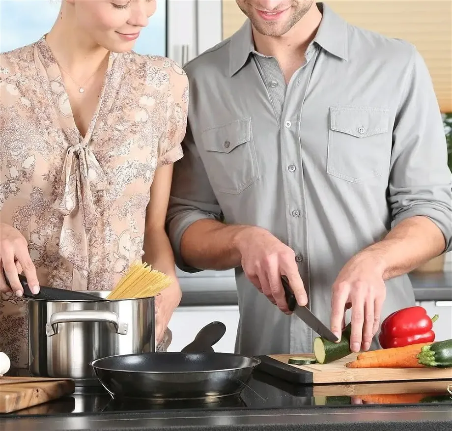 a young couple cooking in the kitchen