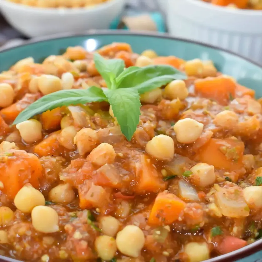 A plate full of vegan chickpea stew with eggplant and sweet potato ¾ shot