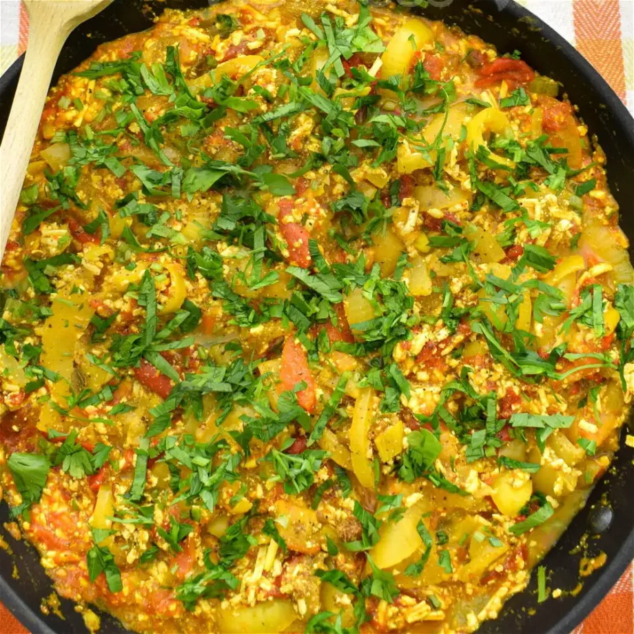 overhead shot of a pan full of cooked scrambled tofu with Roasted peppers