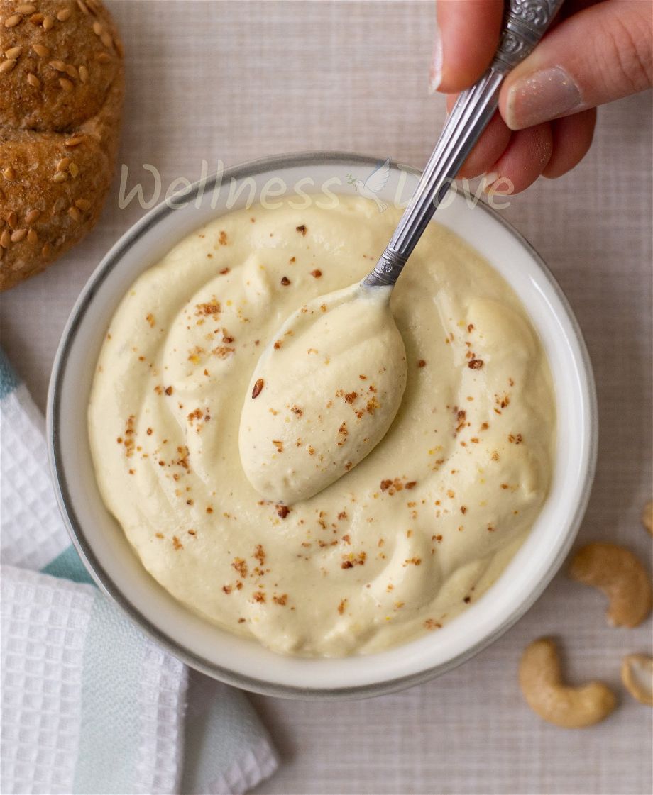 overhead view, a hand taking some of the dip with a spoon