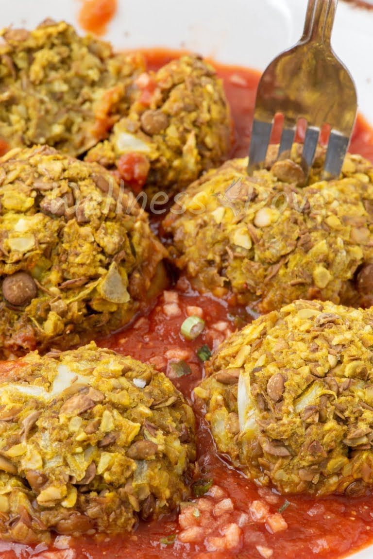 macro view of the meatballs, with a fork taking a meatball