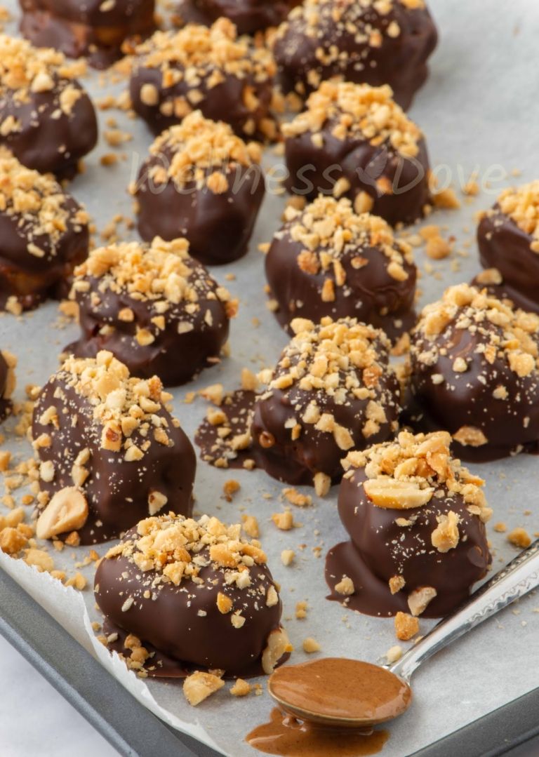 vegan snickers on a tray with a spoon full of peanut butter