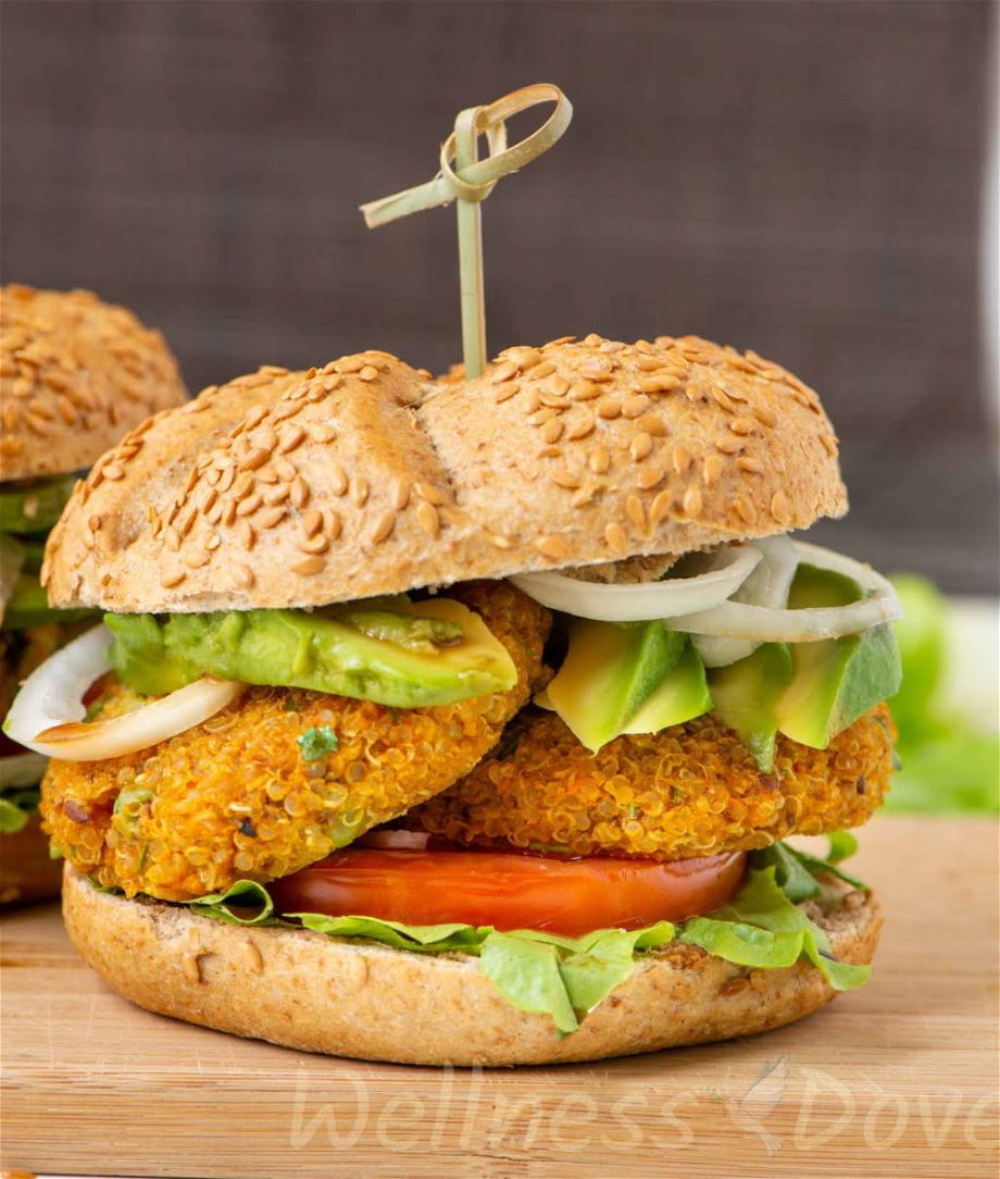 a vegan quinoa burger on a wooden chopping board