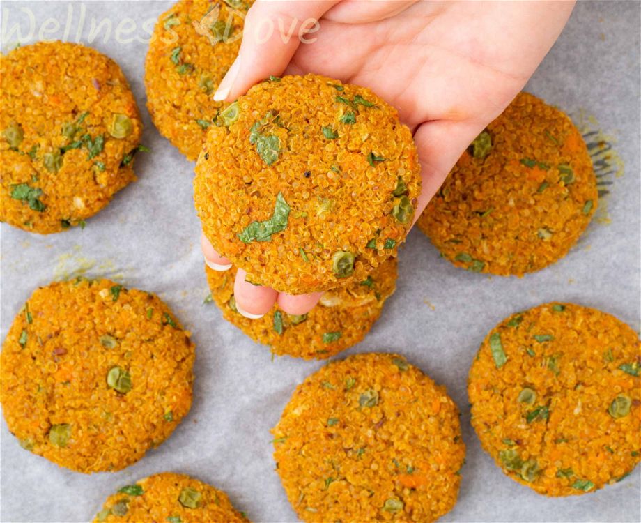 A hand holding a vegan burger patty