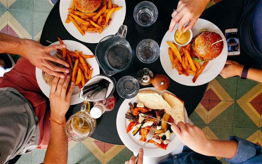 overhead photo of people eating burgers