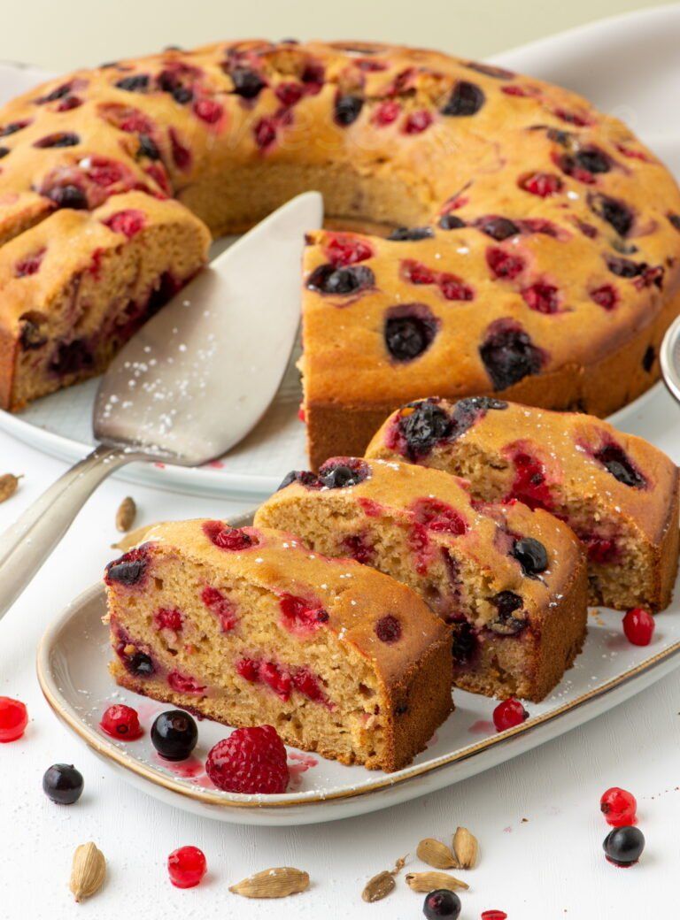 3 pieces of the vegan bundt cake in front of the whole cake