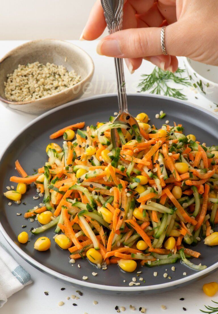 the vegan salad with a hand taking some of it with a fork