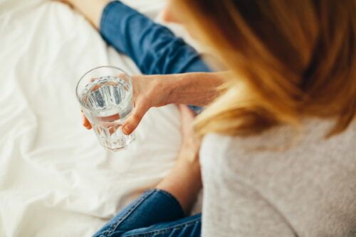 woman holding a cup of water