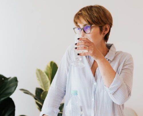 woman drinking water from a glass