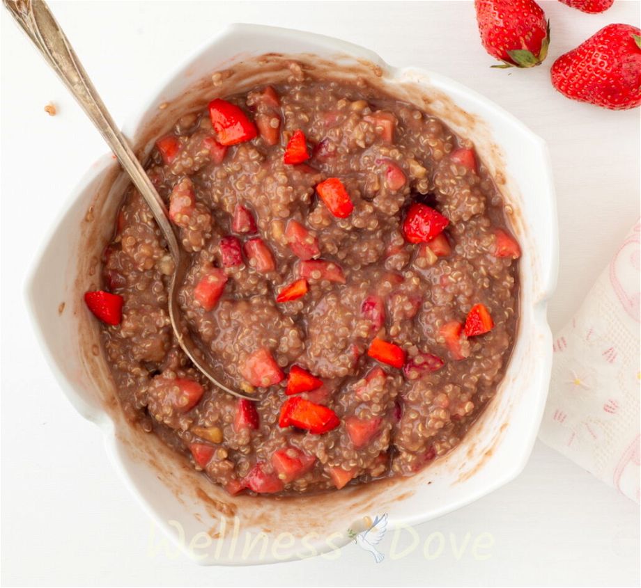 an overhead view of a bowl with the vegan quinoa strawberry breakfast