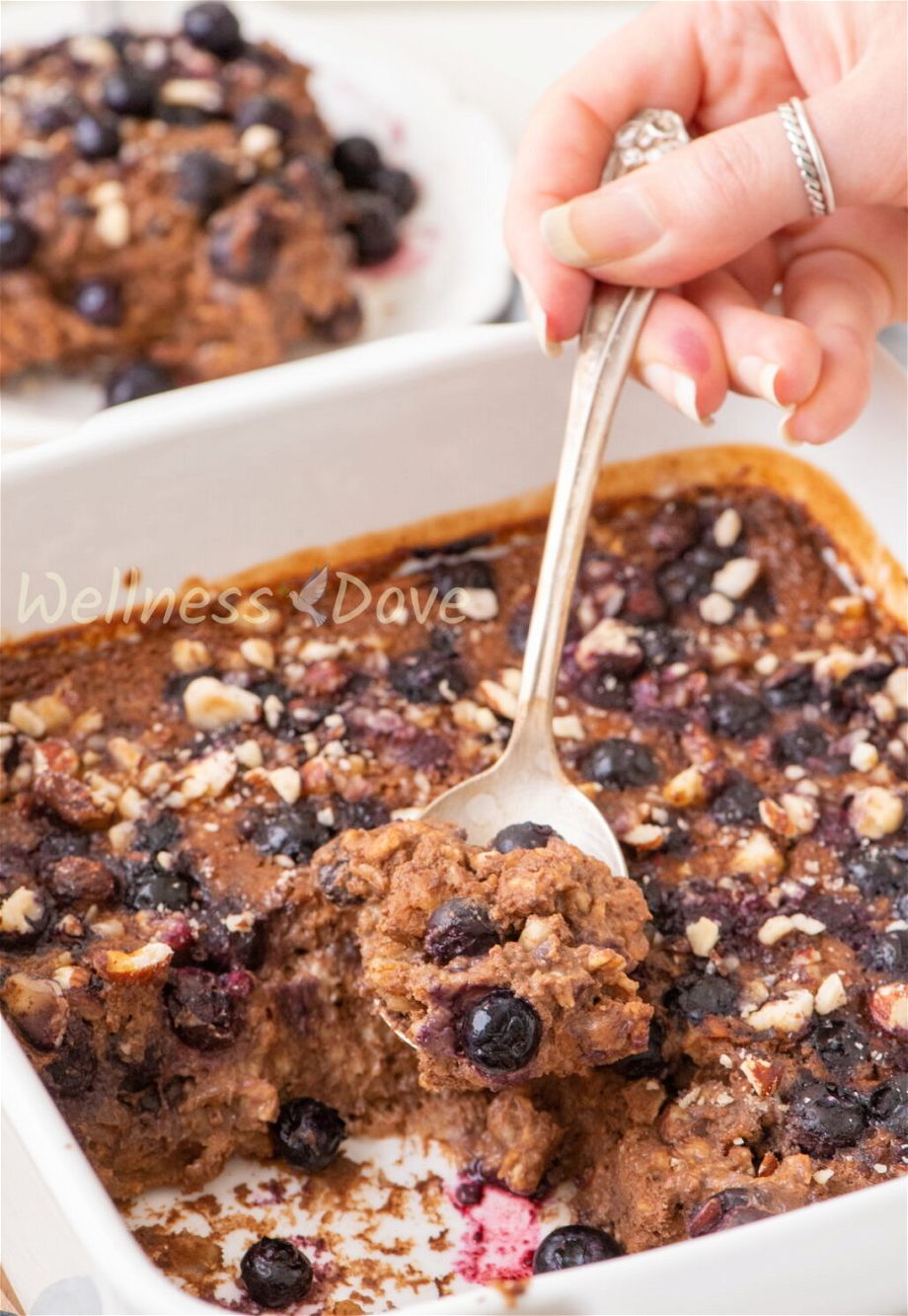 a spoon taking a spoonful of baked oatmeal