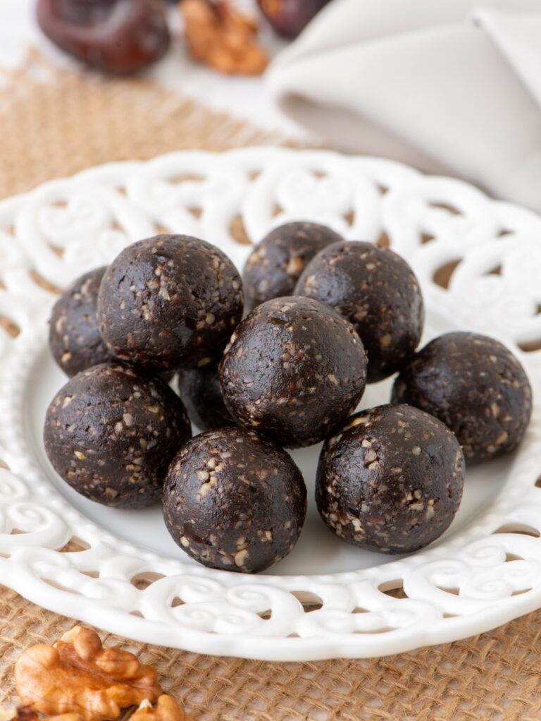 The raw vegan brownie balls , 3/4 view, in a plate