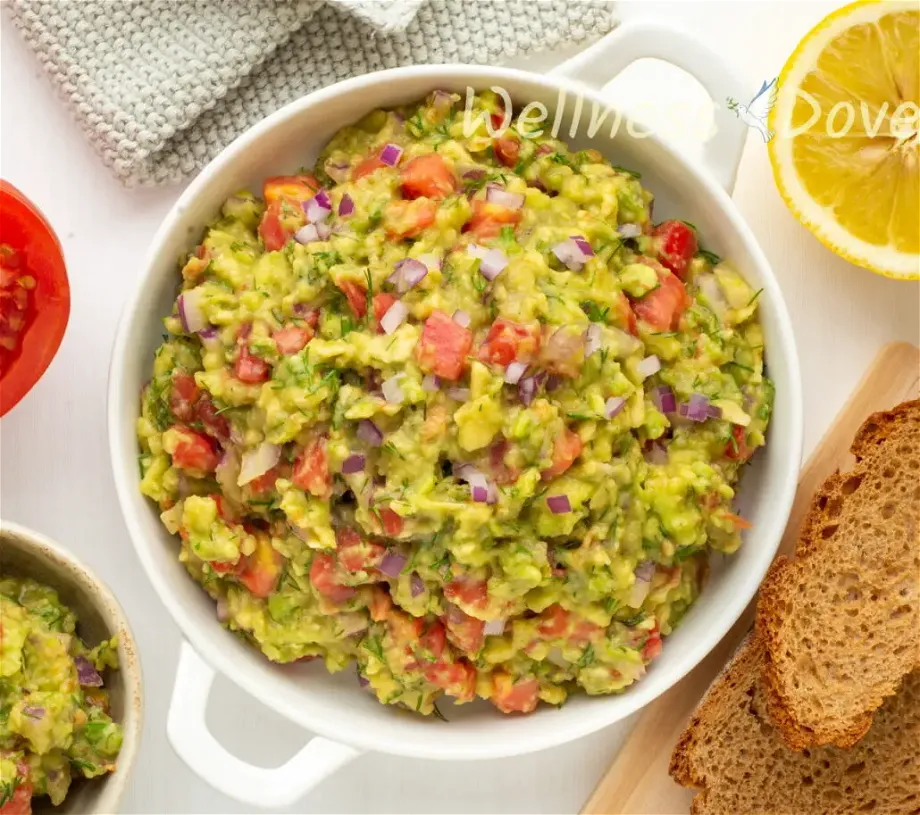 overhead view of the vegan homemade guacamole  in a white bowl