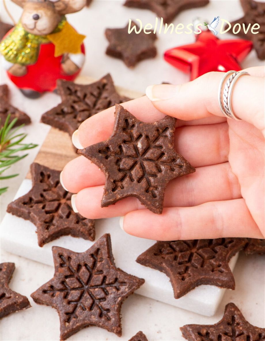 a close up of a vegan no bake sugar-free cookie while a hand is holding it