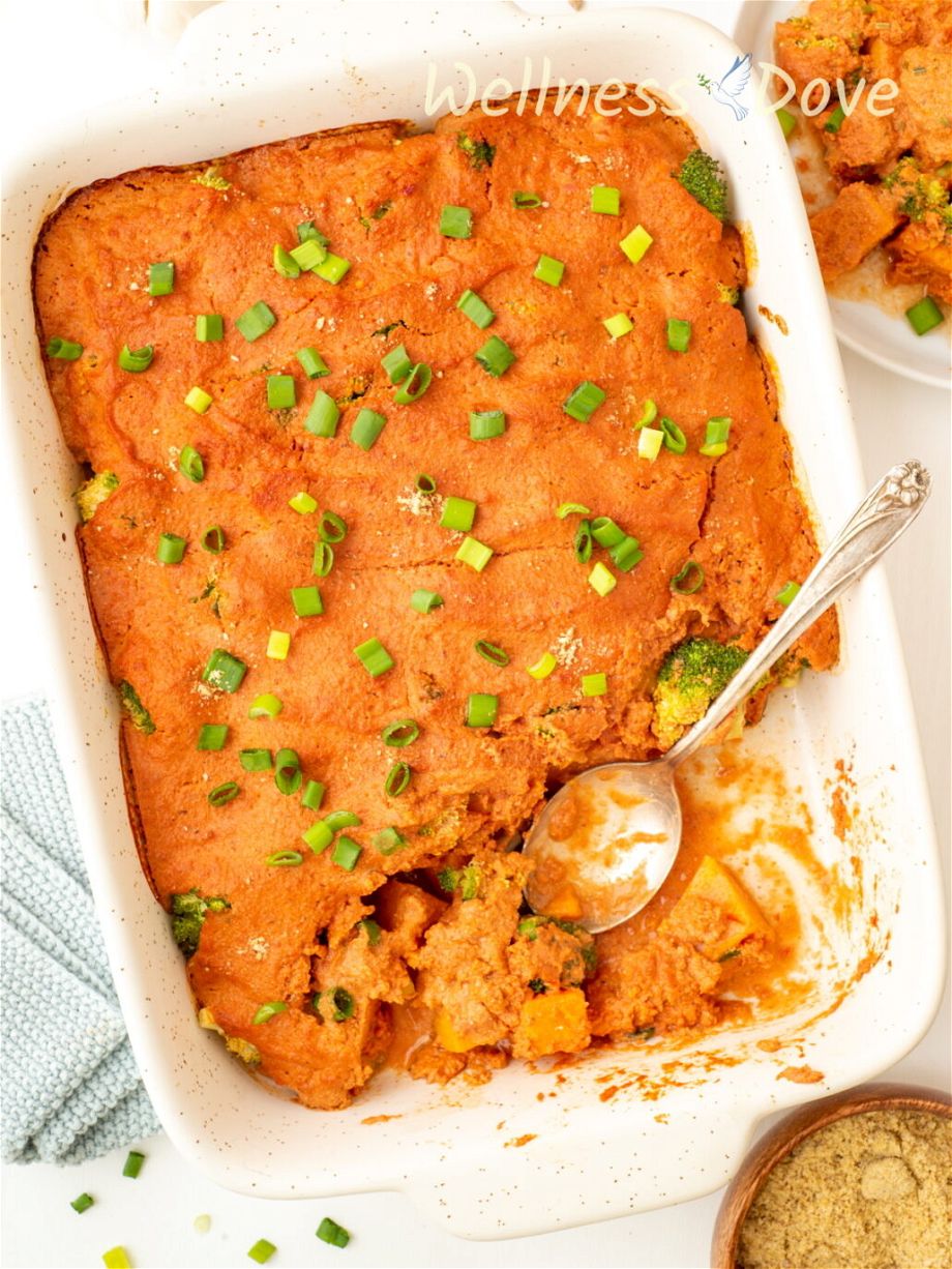 overhead view of  vegan broccoli casserole with a spoon in it